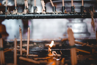 Close-up of burning candles in temple