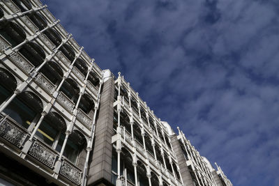 Low angle view of building against cloudy sky