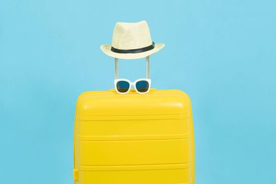 Close-up of yellow hat against blue background