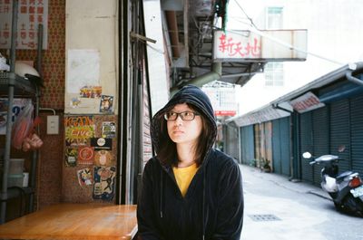 Portrait of woman standing in city