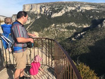 Man with children hiking on mountain