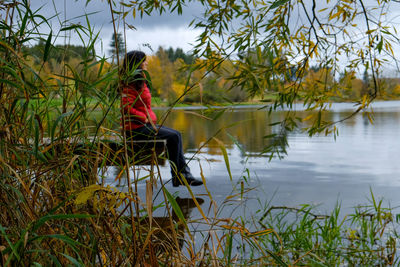 Reflection of person in lake against sky