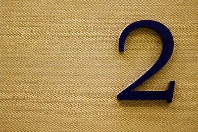 Close-up of text number two on natural rattan background