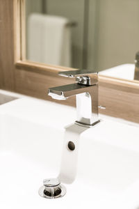 Close-up of faucet in bathroom