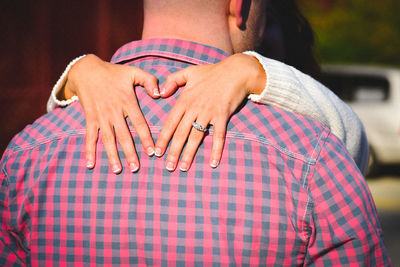 Midsection of couple standing outdoors