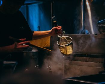 Midsection of man preparing food