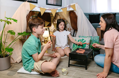 Siblings sitting at home