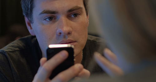 Portrait of young man using mobile phone