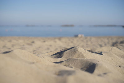 Surface level of sand on beach against sky