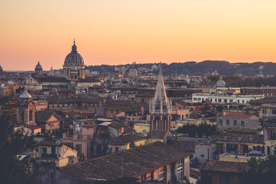 High angle view of buildings in city at sunset