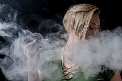 Close-up of man against black background