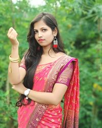 Portrait of young woman standing outdoors