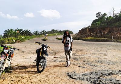 Rear view of man riding bicycle on mine road