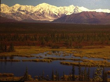 Scenic view of lake and mountains against sky