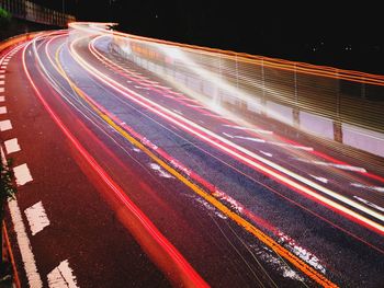 High angle view of light trails on road at night