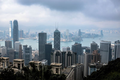 View of buildings in city against cloudy sky