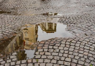 Reflection of buildings in puddle