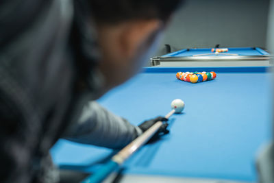 Midsection of man playing pool