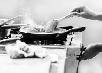 Cropped hands of man preparing food