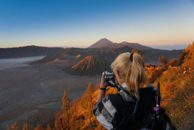 Rear view of woman photographing at bromo-tengger-semeru national park