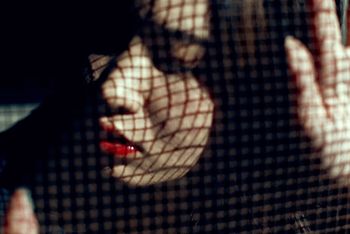 CLOSE-UP OF WOMAN WITH SHADOW ON HAND