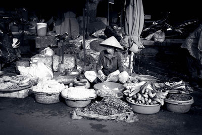 Stack of firewood for sale at market stall