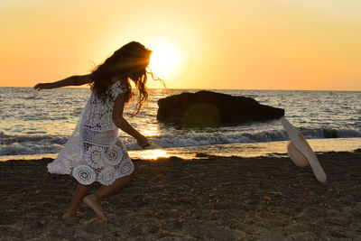 Woman at beach during sunset