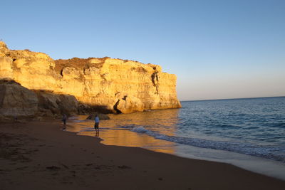 Scenic view of sea with rocks in background