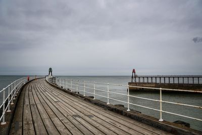 Pier over sea against sky