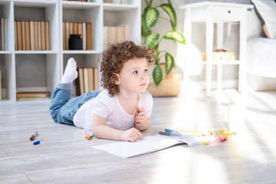 Cute girl lying on floor at home