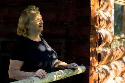 Portrait of elderly woman in glasses close-up on natural background. sunset light on face of senior