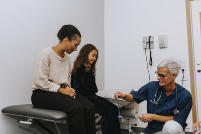 Mother with daughter in doctors office