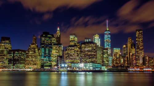 Illuminated buildings against sky at night