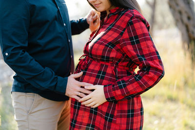 Midsection of woman standing outdoors