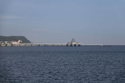 Scenic view of sea and pier against sky