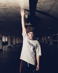 Portrait of man touching ceiling 