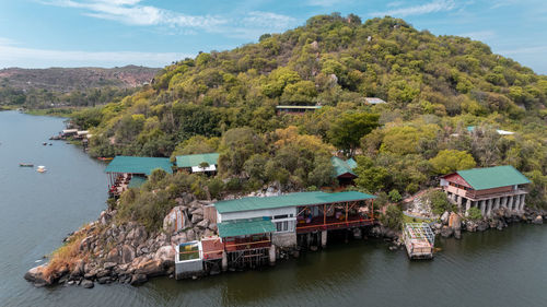 High angle view of townscape by sea against mountain