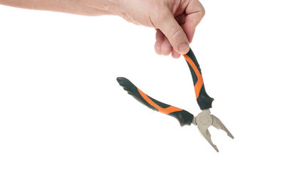 Close-up of hand holding leaf over white background