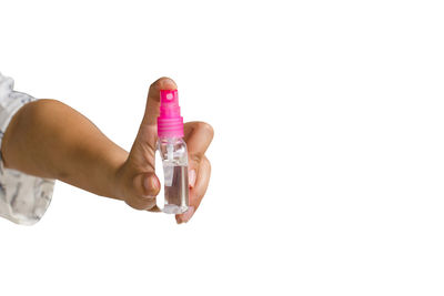 Close-up of hand holding glass over white background