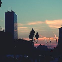 Buildings in city at sunset