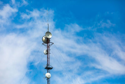 Low angle view of communications tower against sky