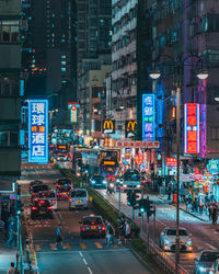 Traffic on city street and buildings at night