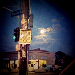 Low angle view of road sign against sky