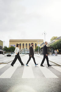 Business people crossing road