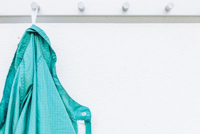 Close-up of shirt hanging against wall