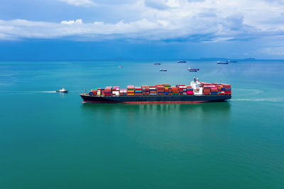 Shipping container sailing on the green sea 