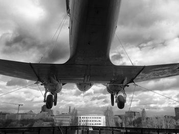 Low angle view of bridge against cloudy sky