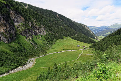 Scenic view of grassy landscape against mountains