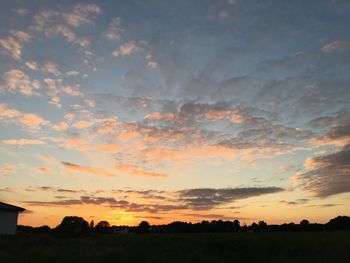 Silhouette landscape against sky during sunset