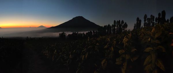 Scenic view of land against sky at sunset